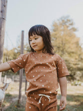 Load image into Gallery viewer, child standing outside wearing terracotta moon organic short sleeve tee
