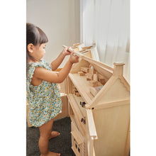 Load image into Gallery viewer, Child playing with a Victorian Dollhouse by Plan Toys
