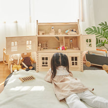 Load image into Gallery viewer, Child playing with a Victorian Dollhouse by Plan Toys
