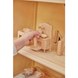 Child playing with PlanToys Victorian Furniture and Doll House