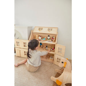 Child playing with PlanToys Victorian Furniture and Doll House