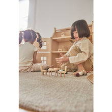 Load image into Gallery viewer, Child playing with PlanToys Victorian Furniture and Doll House
