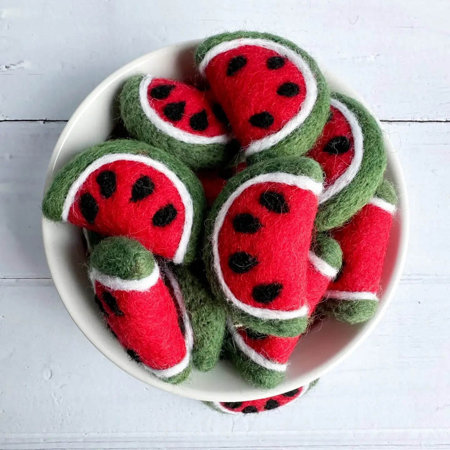 felt watermelon slices in a white ceramic bowl