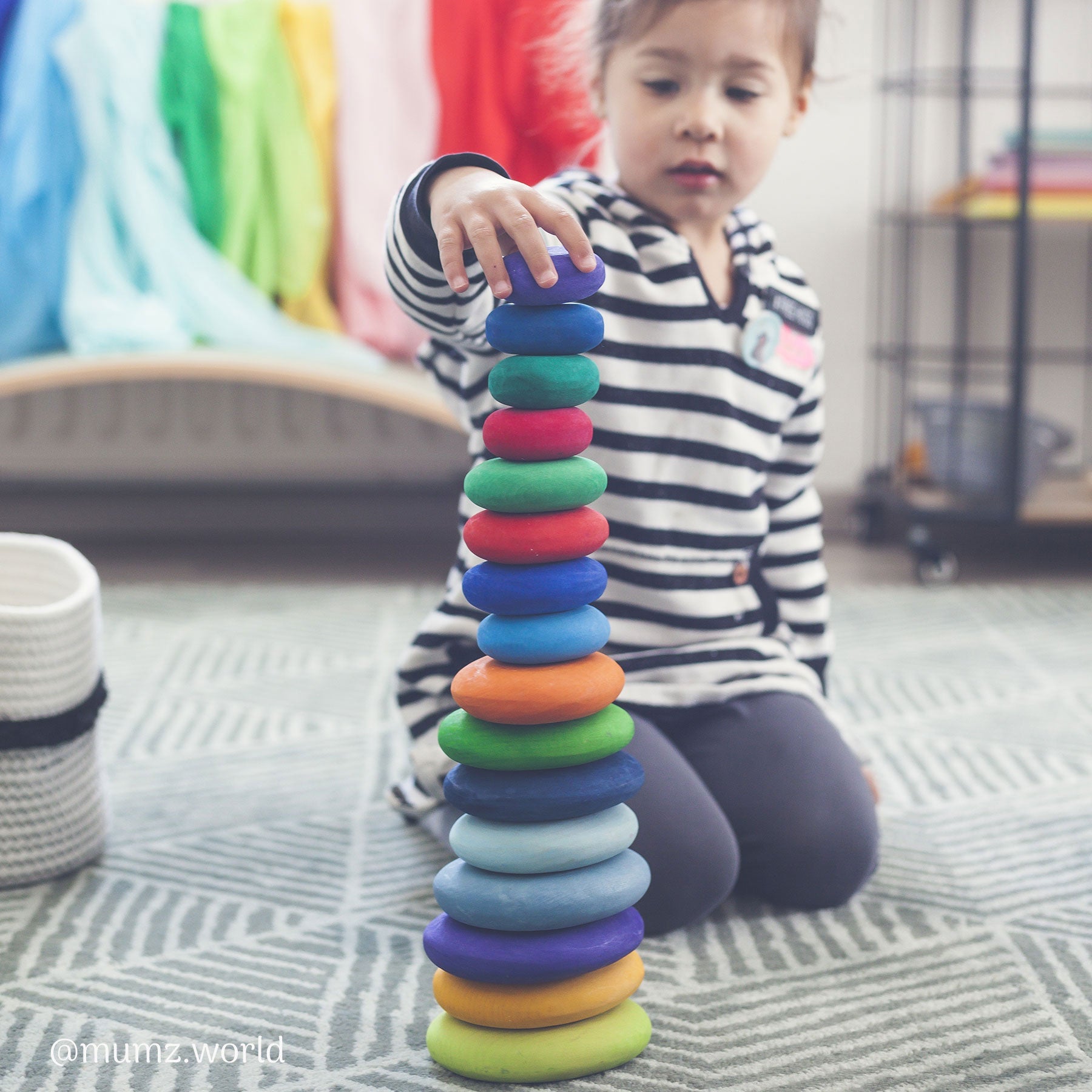 Child playing with stacking pebbles