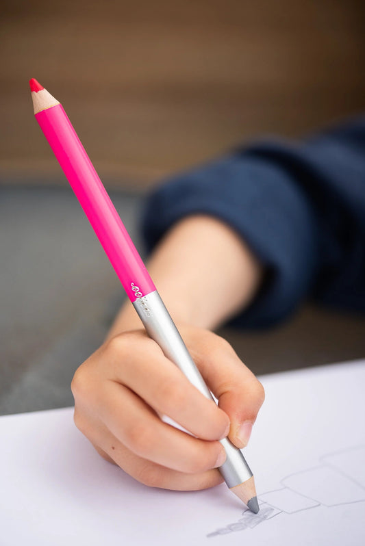 child drawing with the silver side of a double sided jumbo pencil