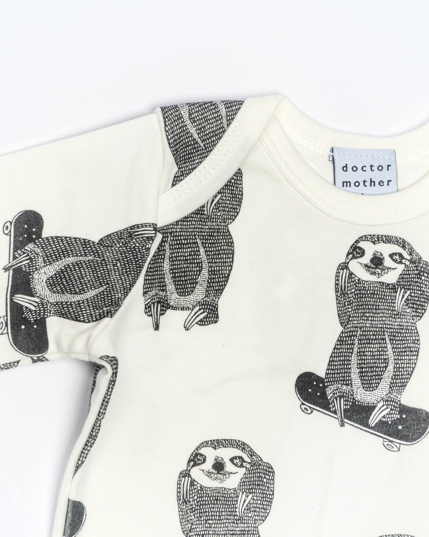 sloth on a skate board romper neckline detail