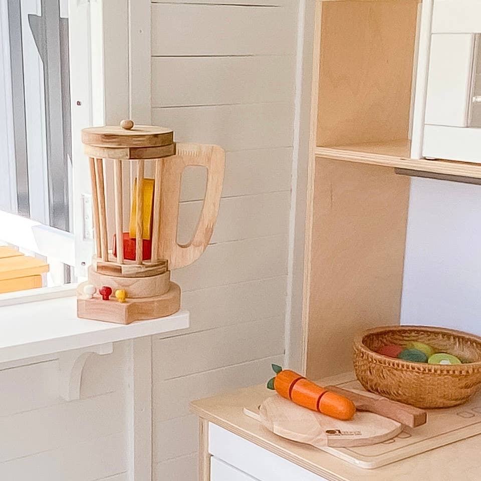 play kitchen with wooden fruits and vegetables and toys, including a wooden blender