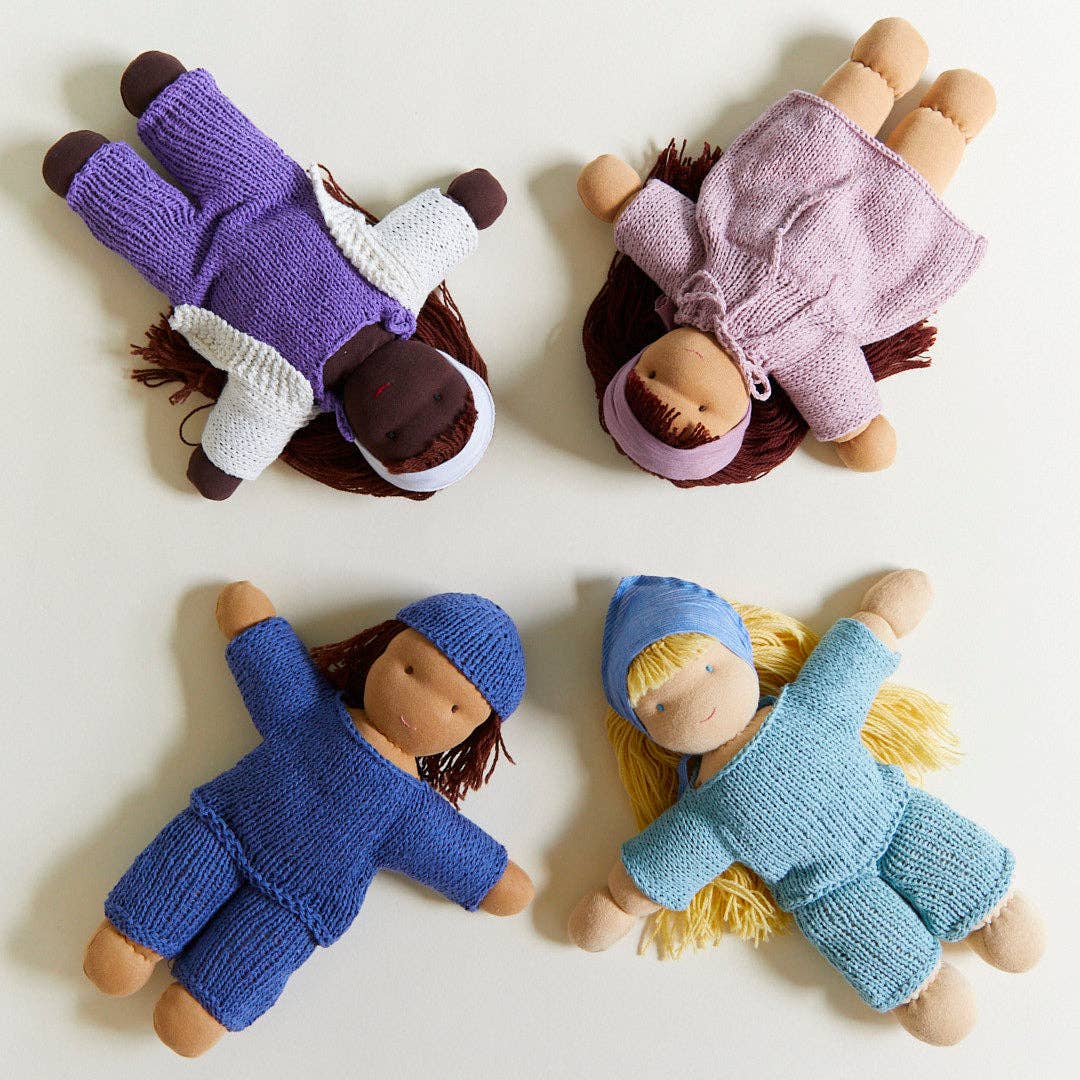 four organic cotton waldorf dolls displayed in a star pattern