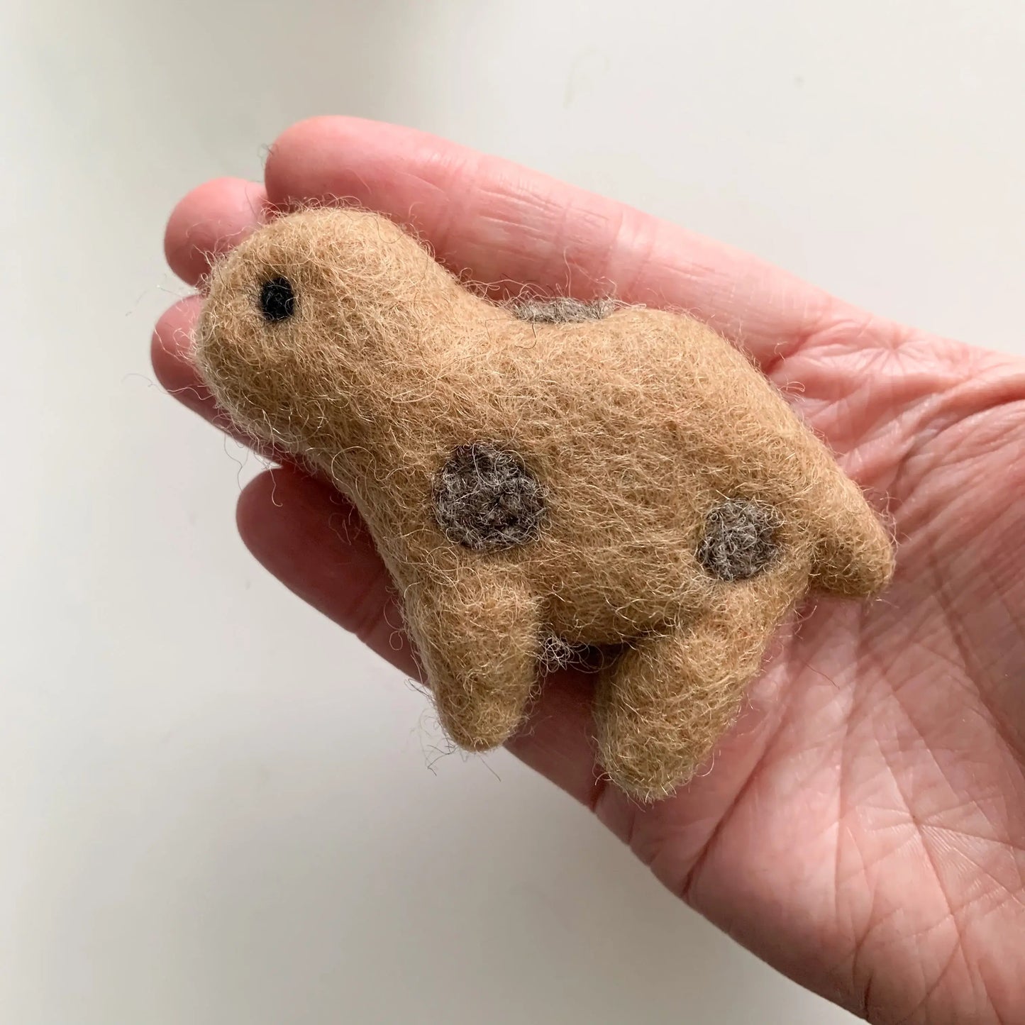 brown baby felt dinosaur