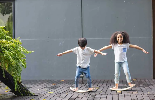 kids playing on the plan toys Balance Board